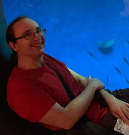 Alan Kerr with book in aquarium